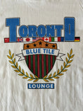 Charger l'image dans la visionneuse de la galerie, Blue Tile Lounge T-Shirt Souvenir 7.0 White graphic close up
